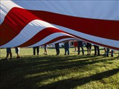 Americana boy-scouts-lift-a-huge-american-flag-at-the-clay-c